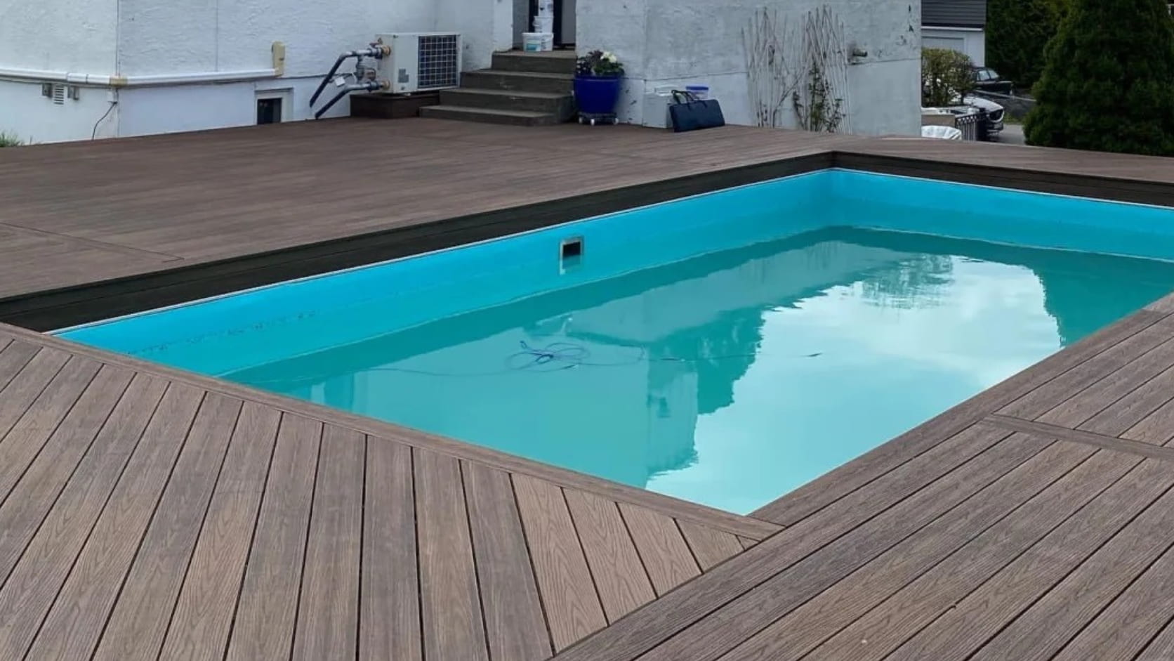 Necowood 3D embossed ASA decking installed around hotel pool area